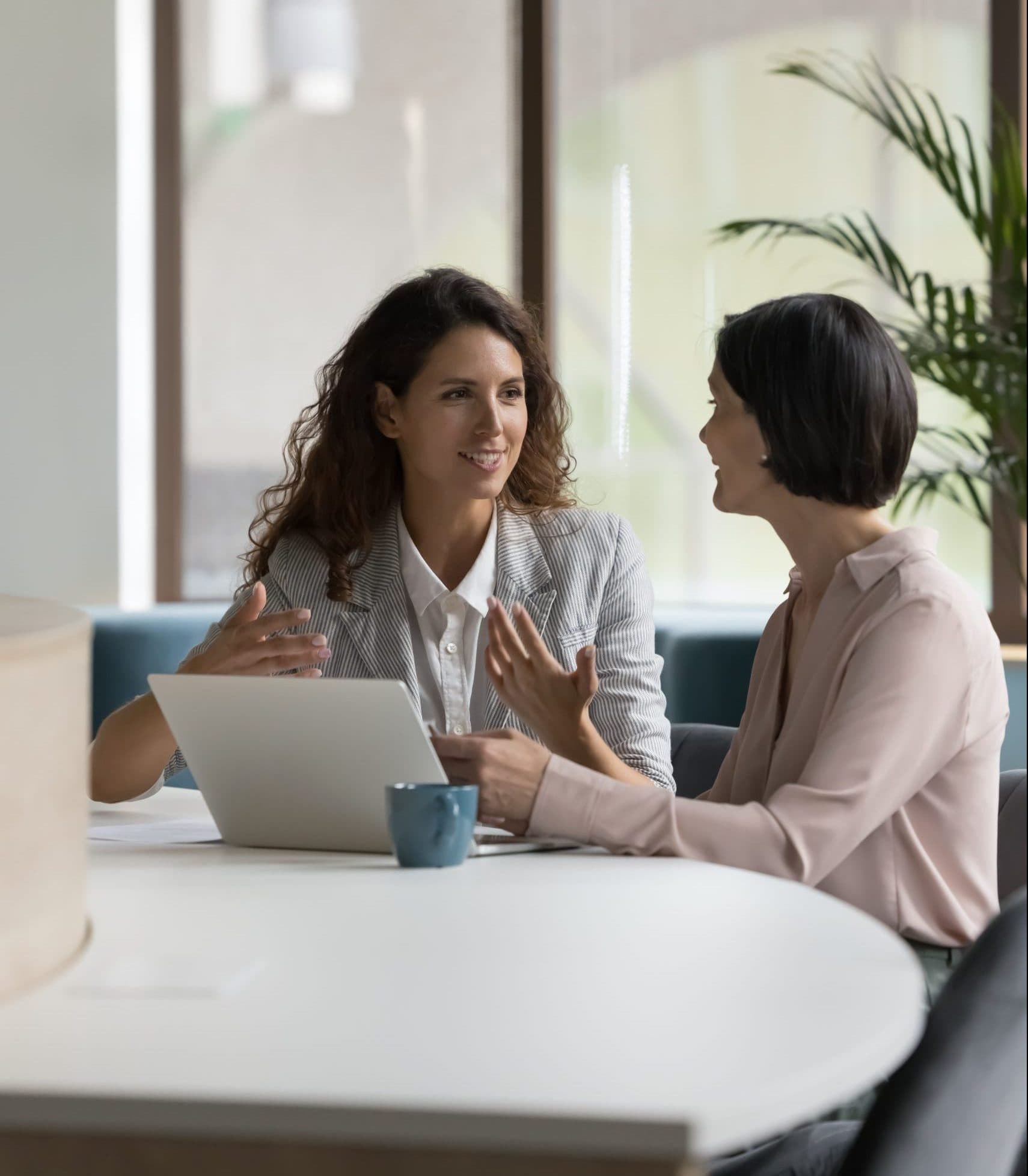 Two happy engaged business professionals women brainstorming on online project